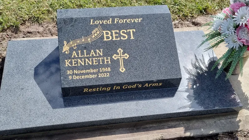 Grey granite desk plaque with gold lettering, music notes and a cross