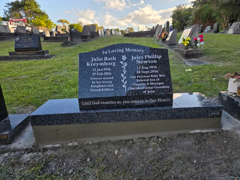 Grey granite double headstone with serpentine top on a grey base