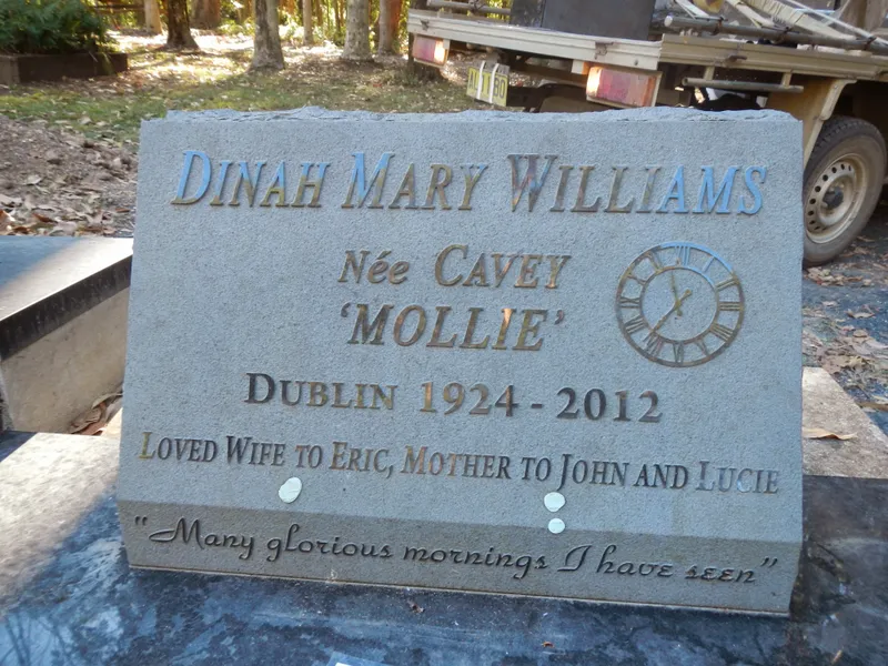 Grey granite plaque with engraved lettering and a clock motif