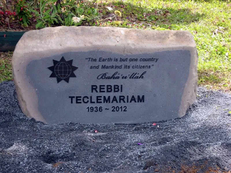 Natural boulder memorial with an inset black granite face