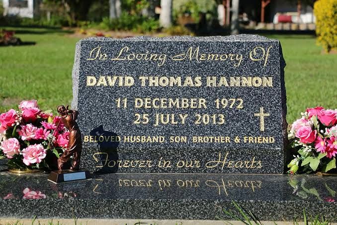 Grey granite sloped desk headstone with gold leaf lettering