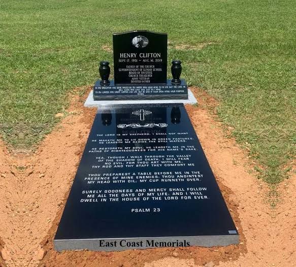 Full black granite monument by East Coast Memorials, with inscribed ledger and vases
